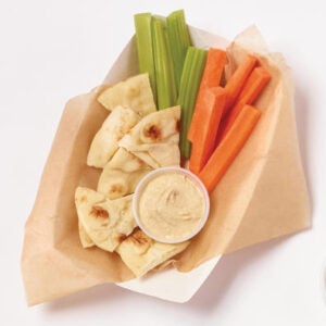 Hummus with pita and carrots in a disposable container
