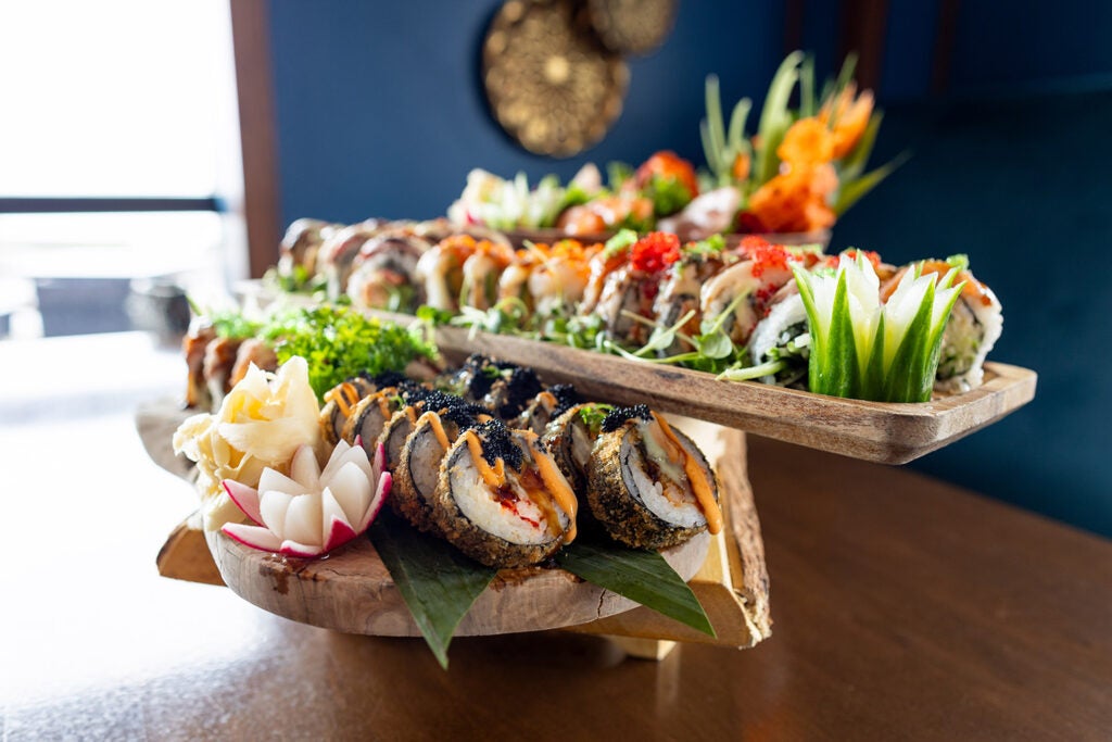 Variety of different sushi rolls served on boards