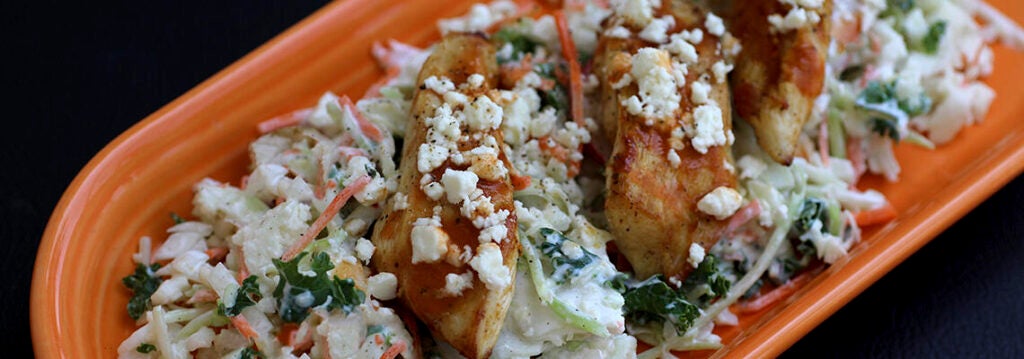 Buffalo Chicken served on top of a hearty slaw with buffalo sauce and blue cheese dressing.