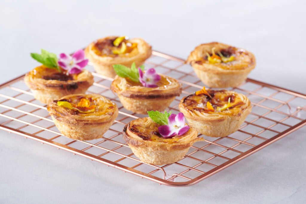 Portugese Custard treats on a wire cooling rack.