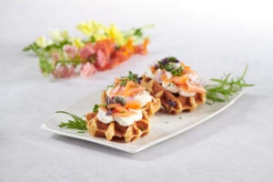 Waffles with salmon and other savoury toppings.