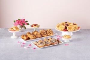 A selection of mother’s day and spring themed brunch foods set up on a table.
